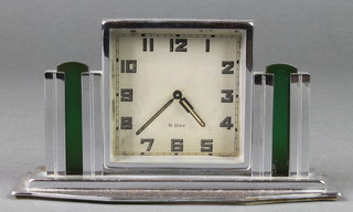 An Art Deco Continental 8 day bedroom timepiece with Arabic numerals contained in a chrome and glass case 
