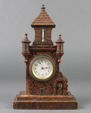 A 19th Century Continental timepiece with paper dial and Arabic numerals, contained in a carved hardwood case in the form of a tower on rocky outcrop 