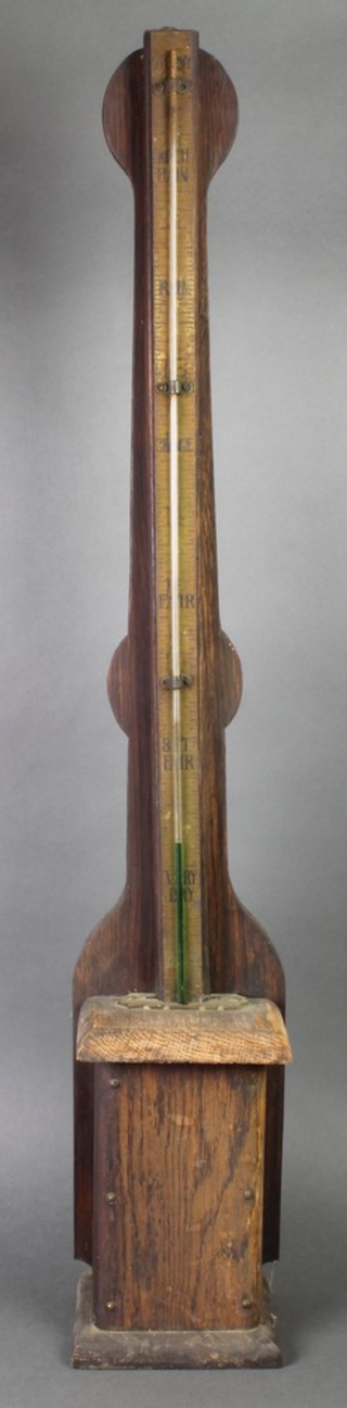 A Victorian mercury barometer with brass dial, contained in a square oak case 