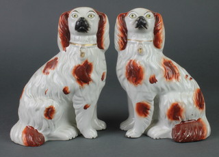 A pair of 19th Century Staffordshire ochre decorated spaniels with separate front leg 8" 