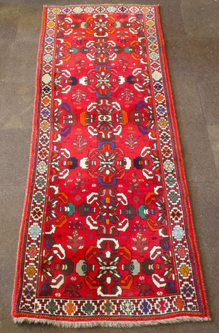 A Persian Qashqai runner with red ground and 7 medallions to the centre 112" x 42" 