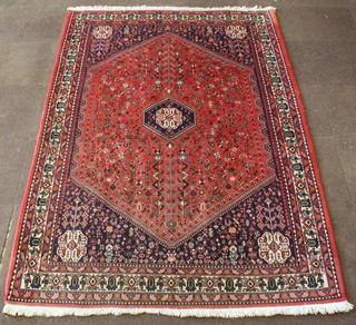 A Persian Abadeh rug with red and blue ground and diamond medallion to the centre 100" x 72" 