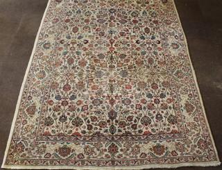 A Persian Tabriz carpet with white and floral ground, some wear 127" x 86" 