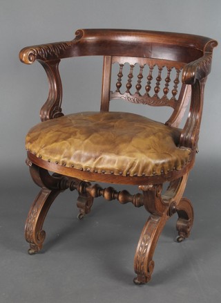 A 19th Century carved walnut tub back chair with bobbin decoration, the seat upholstered in leatherette material, raised on X framed supports 
