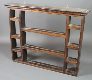 A Georgian oak dresser back or hanging plate rack with moulded and dentil cornice, fitted numerous shelves 37"h x 46 1/2"w x 7"d