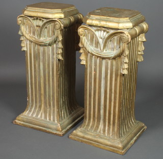 A pair of octagonal fluted gilt painted pedestals in the form of columns 33"h x 13"w x 11 1/2"d 