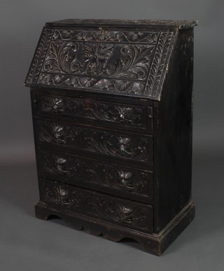 A Victorian carved and ebonised bureau, the fall front revealing a fitted interior above 3 long graduated drawers, raised on a platform base 42"h x 30 1/2"w x 16"d 