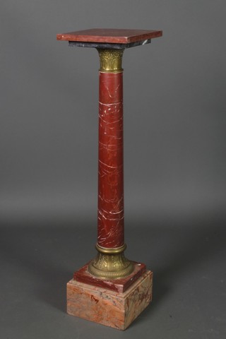 A pink veined marble column, raised on a square stepped base with gilt metal capital and base 42"h x 10" 