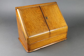 A Victorian honey oak wedge shaped stationery box, the interior fitted 2 glass bottles 11"h x 14 1/2"w x 9"d 