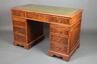 A mahogany kneehole pedestal desk with inset tooled leather writing surface, the frieze with 1 long  and 2 brushing slides above 8 short drawers, raised on bracket feet 30 1/2"h x 48"w x 24"d 