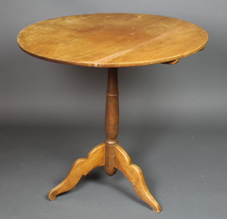 A 19th Century circular bleached mahogany snap top tea table, raised on a turned column and tripod base 29"h x 22" diam. 