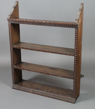 A Victorian carved oak hanging 3 tier wall shelf with carved decoration 36"h x 28"w x 7"d 