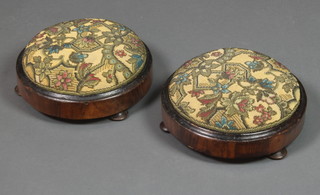 A pair of circular Victorian walnut footstools with bead work tops, raised on 3 turned supports 4"h x 11" diam. 