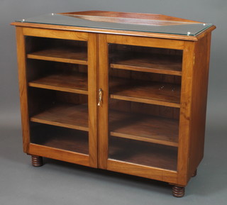 A 19th Century walnut display cabinet, the interior fitted shelves enclosed by panelled doors, raised on ring turned supports 36"h x 43 1/2"w x 16"d 