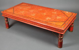 A rectangular Indian hardwood painted table with red ground and floral decoration on turned supports 15"h x 52"w x 27"d 