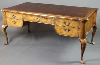 A French Queen Anne style shaped writing table with inset brown leather writing surface above 1 long and 4 short drawers with brass swan neck drop handles, raised on cabriole supports 30"h x 66"w x 35"d 