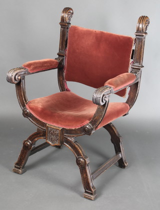 An Italianate style carved oak open frame armchair upholstered in burnt orange draylon 