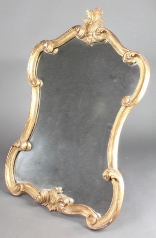 A shaped plate wall mirror contained in a gilt carved wood and plaster frame 35"h x 24"w