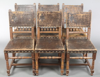 A set of 6 French carved walnut dining chairs with bobbin turned decoration, the seats and backs upholstered in sculptured leather, raised on turned and block supports with H framed stretcher 