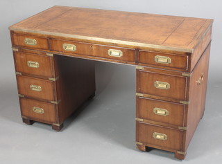 A Military style pedestal desk with brass banding and brown leather writing surface above 1 long and 8 short drawers with brass countersunk handles, raised on bun feet 29"h x 48"w x 24"d 