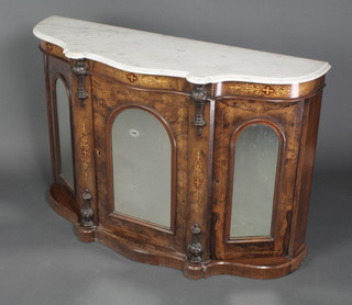 A Victorian inlaid figured walnut side cabinet of serpentine outline with white veined marble top, fitted 3 cupboards enclosed by arched mirror panelled doors 32"h x 47 1/2"w x 14"d 