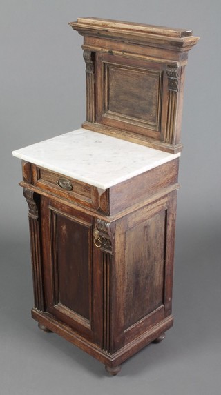 A 19th Century French carved oak bedside cabinet with raised back and white veined marble top, fitted  1 long drawer above a cupboard enclosed by a panelled door, raised on bun feet 45"h x 15"w x 16 1/2"d 