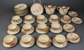 An early 20th Century Satsuma part teaset comprising teapot, 2 handled sugar bowl, 6 tea cups, 12 saucers and 10 side plates, decorated with flowers with seal mark to base together with a coffee can and saucer decorated with an extensive procession of figures and 5 saucers 