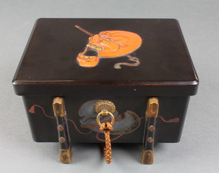 A Meiji Period Japanese lacquer casket, the black ground decorated with a red Oni mask having gilt metal mounts and a silk cord in a fitted box 5"h x 7 1/2"w x 5 1/2"d 