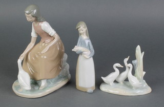 A Nao figure of a girl with goose 8", a ditto of 3 geese 5" and a Lladro figure of a girl holding a piglet 7" 