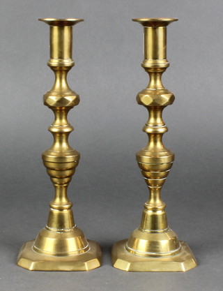 A pair of Victorian brass candlesticks with knopped stems, raised on square bases with ejectors 10"h 