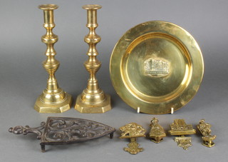 A pair of 19th Century brass candlesticks with knopped stems, a circular brass dish decorated Newark Castle 9", pierced iron trivet and 4 brass internal door knockers 