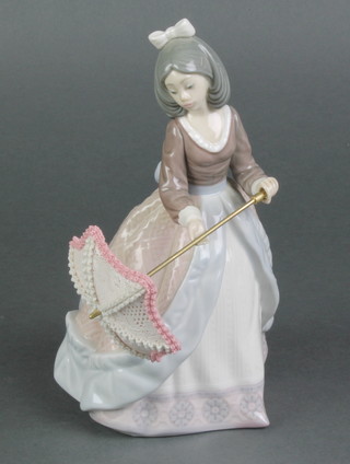 A Lladro figure of a lady holding a parasol 5210 7 1/2" 