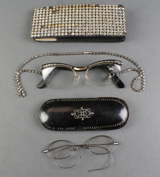 A Victorian black lacquered oval spectacle case, a pair of polished steel spectacles, a pair of lady's 1950's spectacles  and case 
