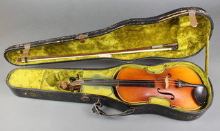 A violin with 2 piece back, slight hole to back (f), bears label Mittenwald complete with bow contained in a wooden carrying case 