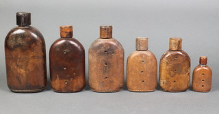 6 graduated leather covered bottles largest 8" - smallest 3 1/2" 