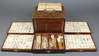 A bone and bamboo Mahjong set contained in a wooden carrying box 