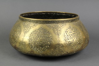 A circular Persian engraved brass bowl of cushion form 16"