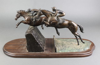Harriet Glen, a bronze racing trophy in the form of 2 steeple chasers at fence, signed, marked 12/25 24" 