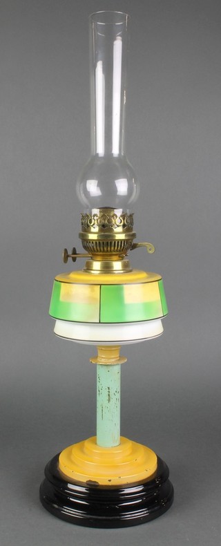 An Art Deco glass and iron oil lamp with glass reservoir 