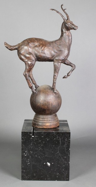 A bronzed figure of a standing deer, raised on an orb with associated square marble base 36"h 