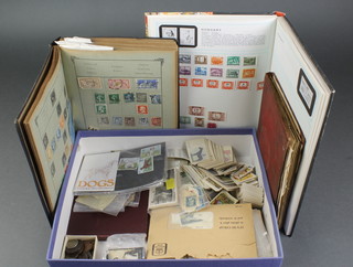 A Stanley Gibbons album of mint and used stamps, 2 other albums of world stamps and a small collection of cigarette cards, coins 
