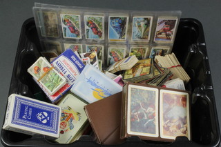 A collection of tea cards, cigarette cards and playing cards