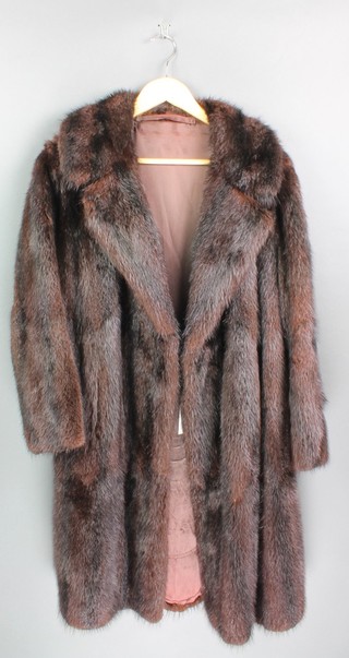 A lady's black full length fur coat and a lady's quarter length brown mink coat 