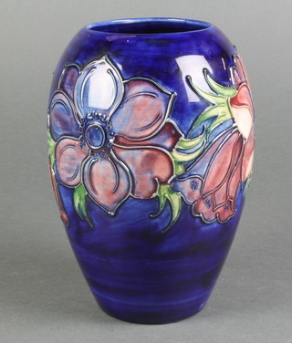 A late 20th Century Moorcroft oviform vase, the blue ground decorated with anemone with impressed marks 7" 