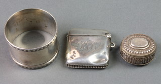 A silver vesta, a ditto napkin ring and a Continental repousse silver box 