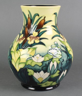 A late 20th century Moorcroft oviform vase, the blue and yellow gold decorated with irises and bull rushes, printed marks 10" 