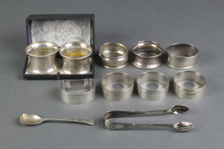 9 silver napkin rings, mixed dates, a pair of plated nips and a spoon, 120 grams