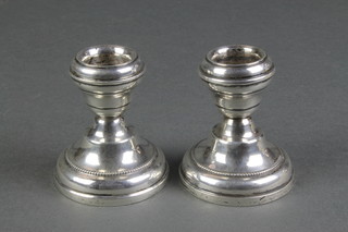 A pair of silver waisted dwarf candlesticks, Birmingham 1931 2 1/2" 