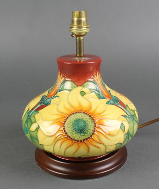 A late 20th Century Moorcroft squat shaped baluster table lamp, the red ground decorated with sunflowers 8" 