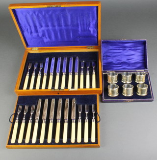 An Edwardian canteen of silver plated dessert eaters for 12 and a set of 6 plated napkin rings 